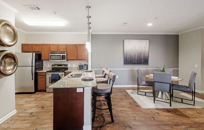a kitchen and dining room area with a table and chairs at Cumberland Place Apartment Homes, Tyler, Texas