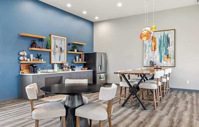 A modern kitchen with a dining table and chairs.