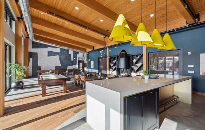 A modern kitchen with a wooden ceiling and a white island.