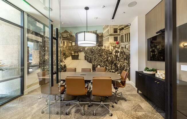 a conference room with a large table and chairs and a mural on the wall