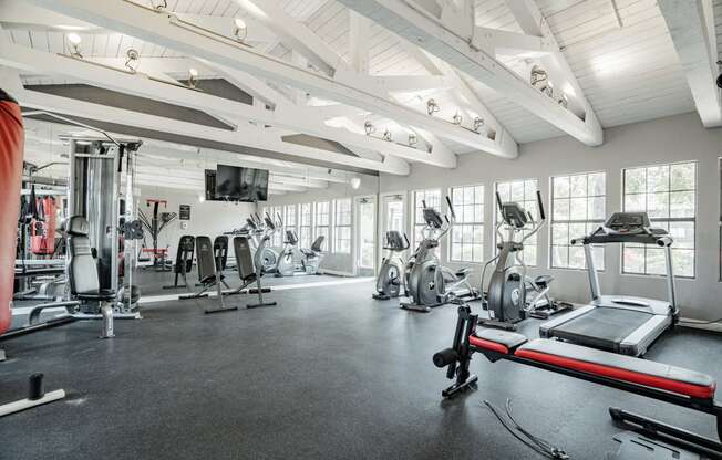 the gym with treadmills and other exercise equipment at the belgard apartments