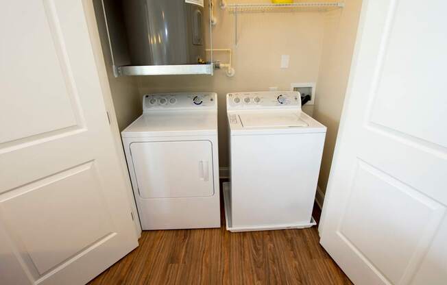 A small laundry room with a washer and dryer.