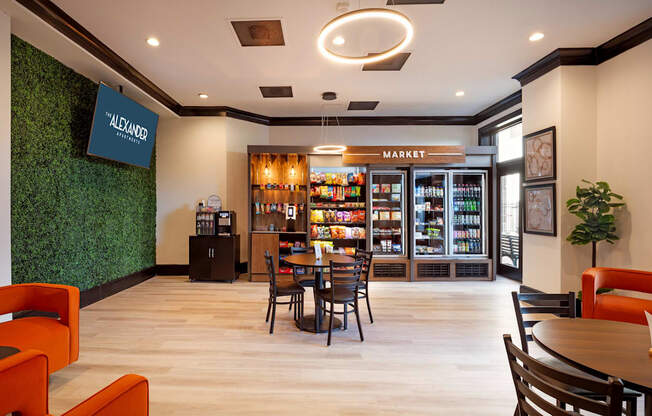 A modern cafe with a green wall and a market section.