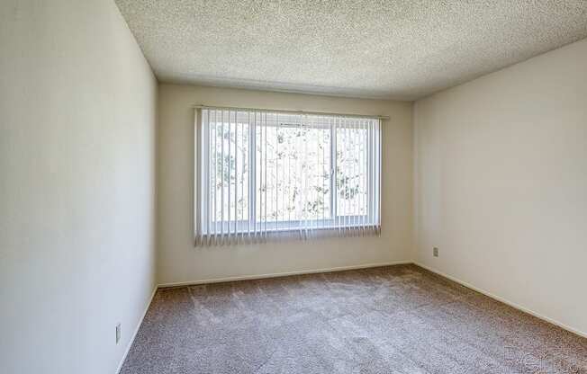 an empty bedroom with a large window at Terrace View Apartments, Daly City, 94015