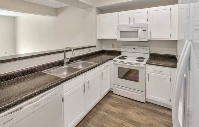 This is a photo of the kitchen of the 1280 square foot 2 bedroom, 2 and 1/2 bath Oakwood floor plan at Washington Park Apartments in Centerville, OH.