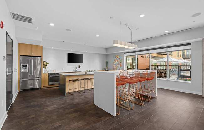 A modern kitchen with a white island and wooden floors.