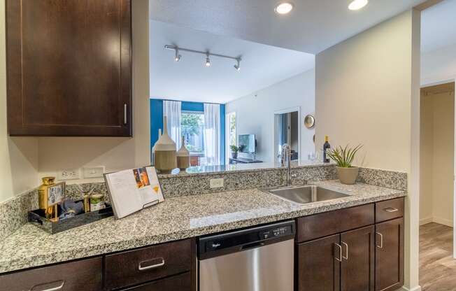 redesigned kitchen with granite counter tops and stainless steel appliances and a window