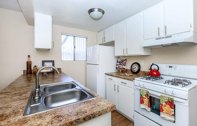a kitchen with a sink and a refrigerator