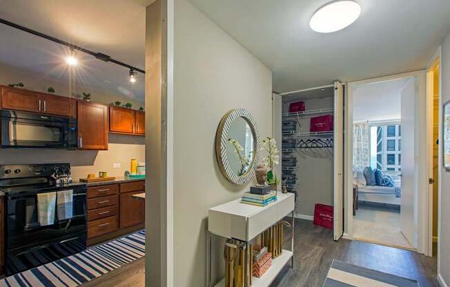 a view of a living room and a kitchen with the door open