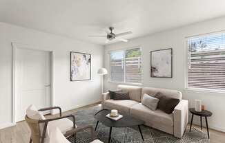 A living room with a couch, chair, and table.