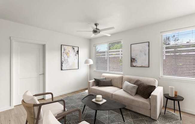 A living room with a couch, chair, and table.