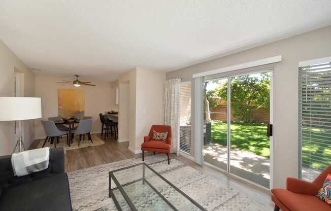 an open living room and dining room with sliding glass doors to a patio