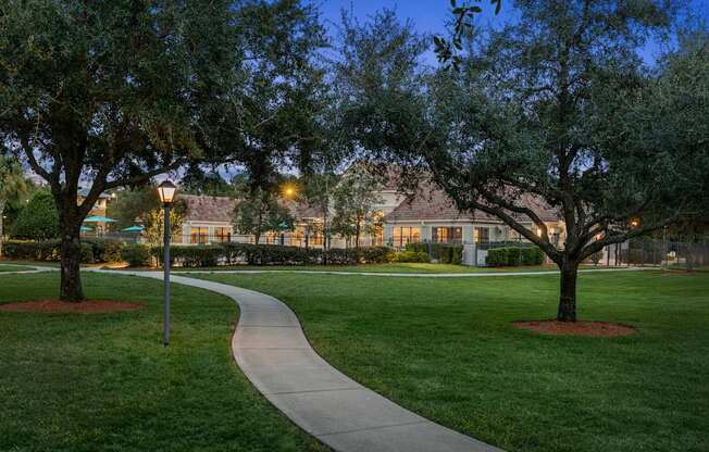 A pathway leads through a grassy area with trees on either side.