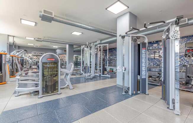 a spacious fitness center with cardio machines and weights