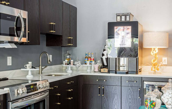 a kitchen with dark cabinets and a white and black striped floor
