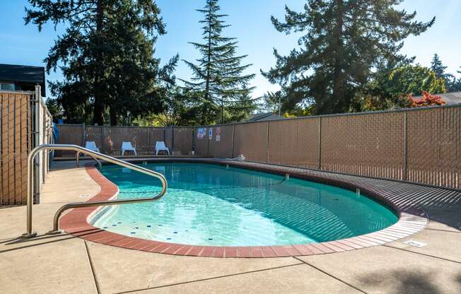 a resort style pool with a fence around it