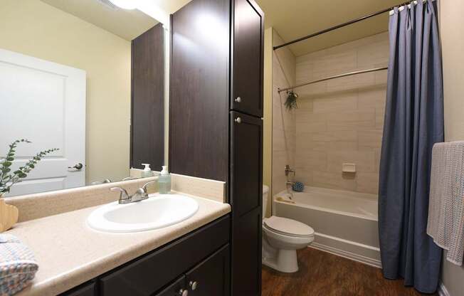 A bathroom with a sink, toilet, and bathtub.