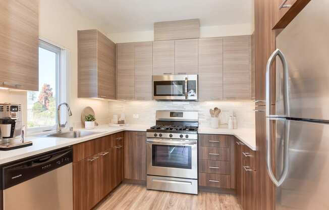 a kitchen with stainless steel appliances and wooden cabinets
