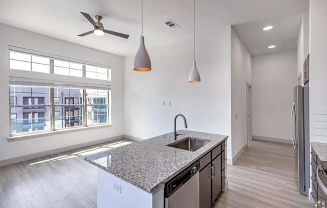a kitchen with a granite counter top and a large window