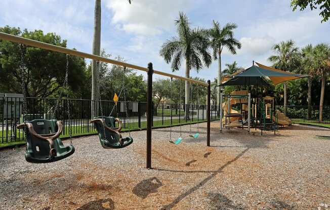a playground with a swing set and a jungle gym