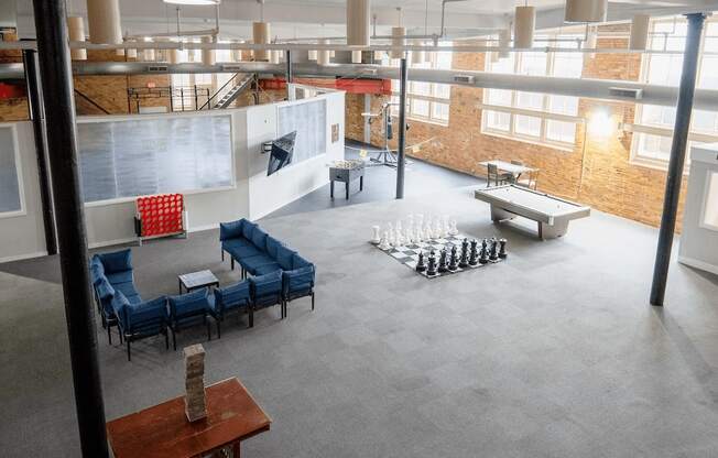 A room with a chess board and chairs.