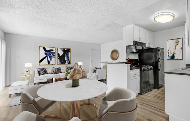 an apartment living room and kitchen with a table and chairs