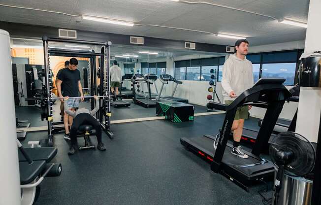 A man is working out on a treadmill in a gym.