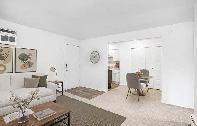 A living and dining room with plush carpeting at Fairlane Apartments, Springfield, Michigan