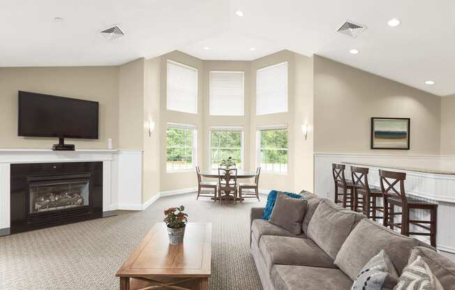 a living room with a couch and a table and a fireplace