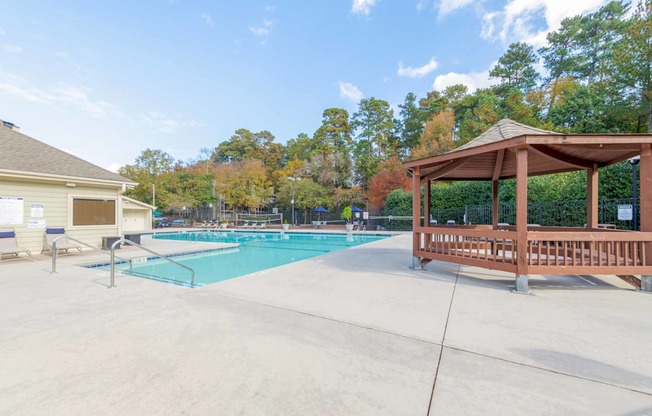 A pool with a gazebo next to it.