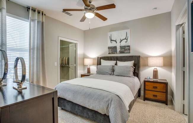 Large bedroom with carpet flooring, natural light, ceiling fan