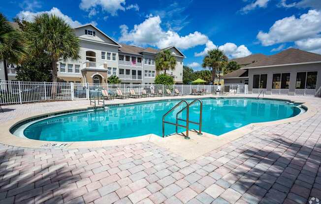 A large swimming pool with a metal ladder in the middle of it.