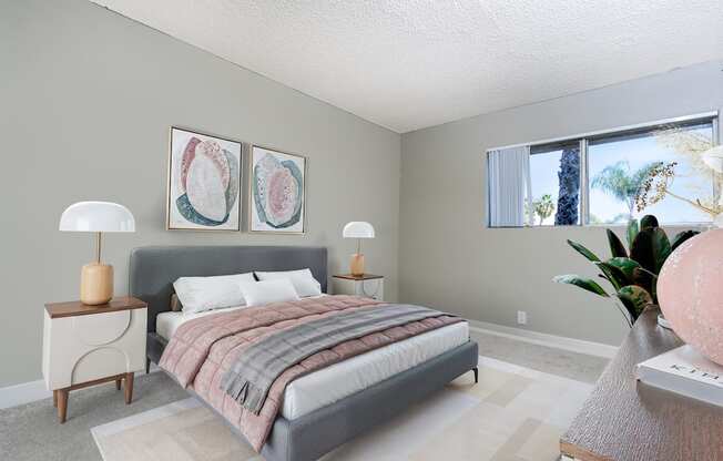 A bedroom with a bed, nightstand, and two lamps.