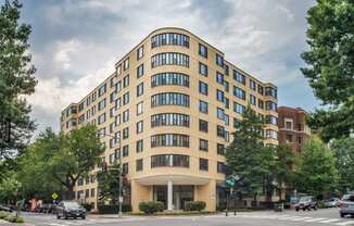a yellow building on the corner of a city street