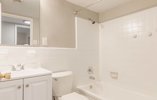 a bathroom with a toilet sink and bathtub