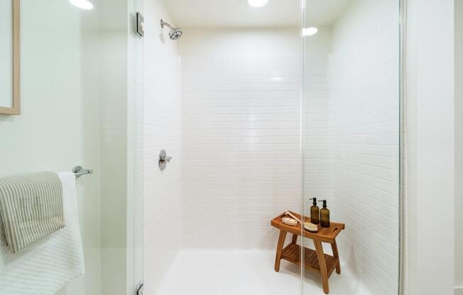 Spa-inspired bathrooms feature frameless glass showers, contemporary finishes, and clean, modern design elements.