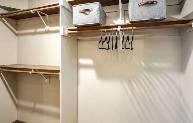 A white closet with two shelves at Tranquility Pointe, Omaha