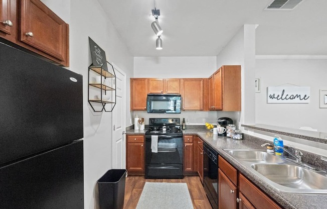 a kitchen with wood cabinets and black appliances