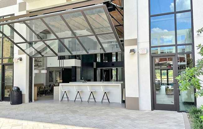 Impressive multi-story clubhouse with glass garage-style doors that open to outside