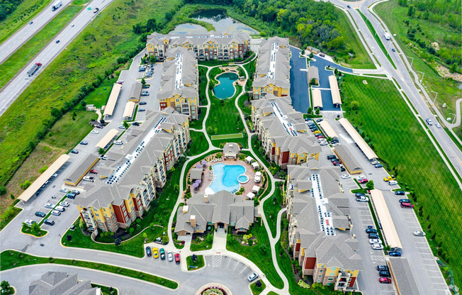 A bird's eye view of a residential complex with a swimming pool.