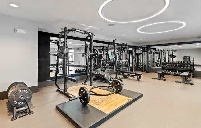 A gym with a variety of equipment including weights and machines