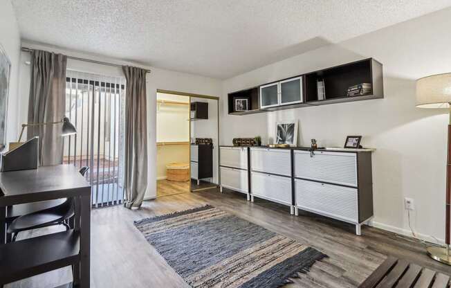 A living room with a dining table and chairs.