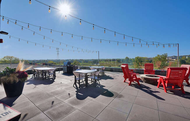 A sunny day at an outdoor seating area with tables and chairs.