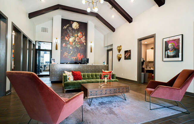 a living room with a couch and chairs and a table