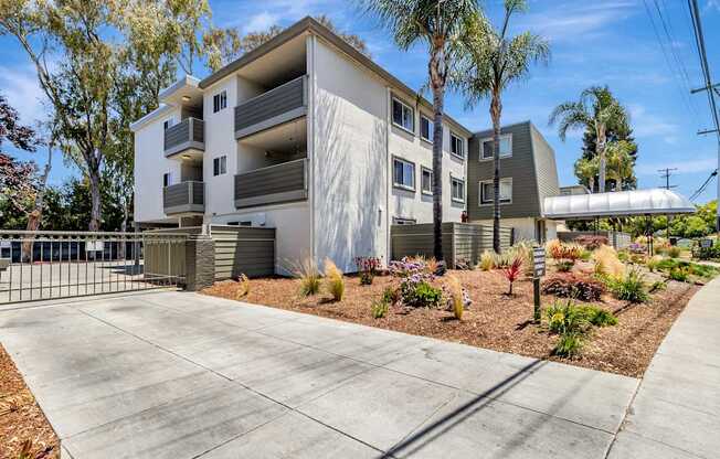 A modern apartment building with a driveway in front.