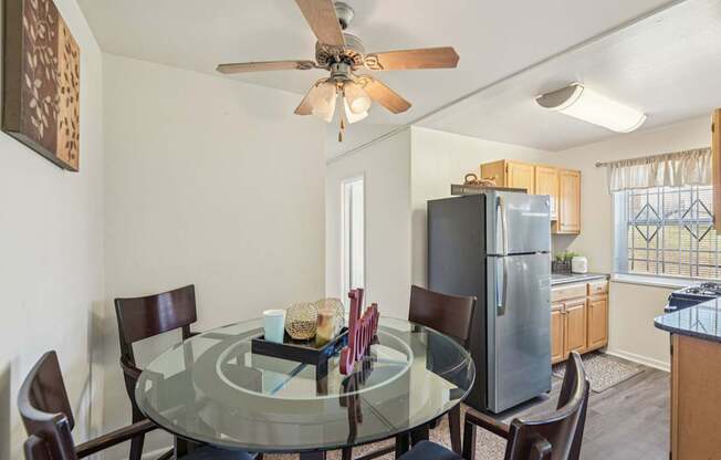 A dining room with a glass table and chairs.