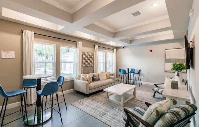 a living room with a couch and chairs and a table