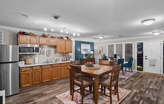 a kitchen and dining room with a table and chairs