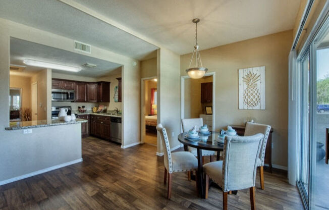 a dining room with tables and chairs and a mirrored wall at Villas on Bell, Phoenix, AZ