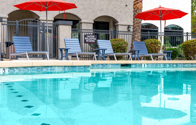 swimming pool with lounge seating and umbrellas